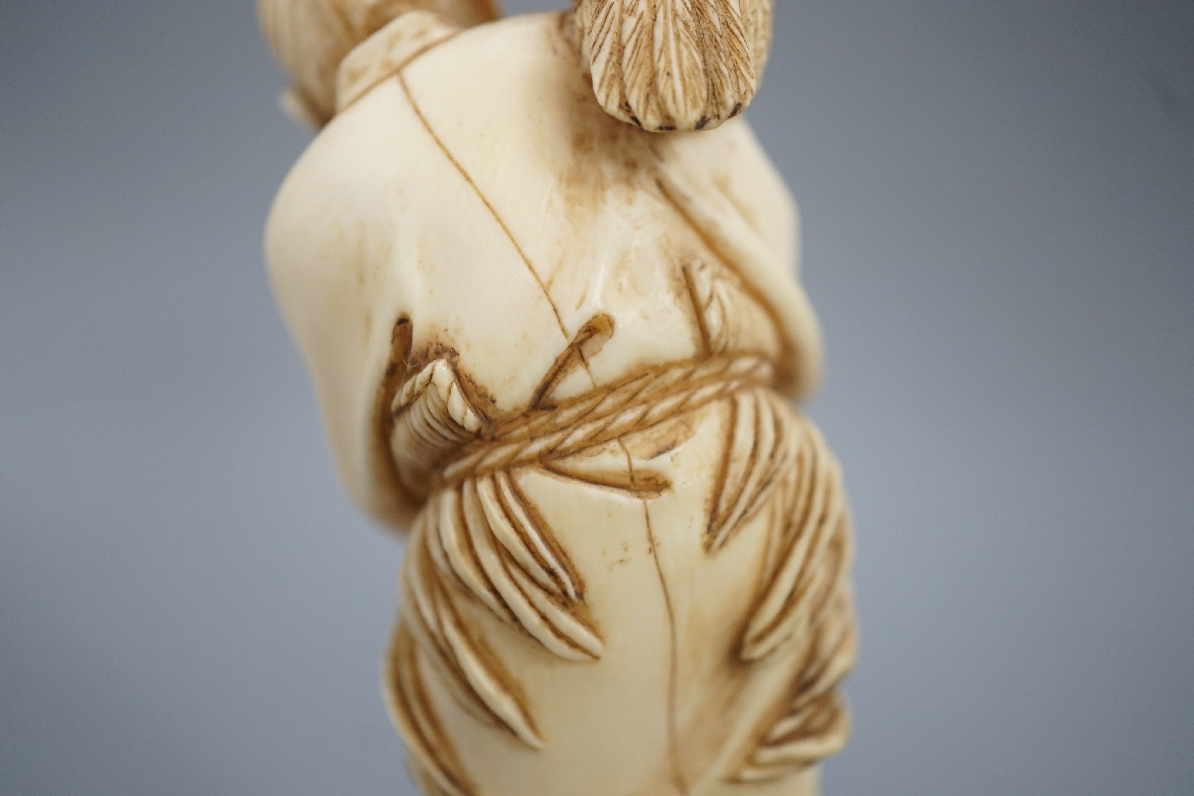 A Japanese ivory okimono of a cormorant fisherman, signed, Meiji period, 11cm and a small carving of a monkey
